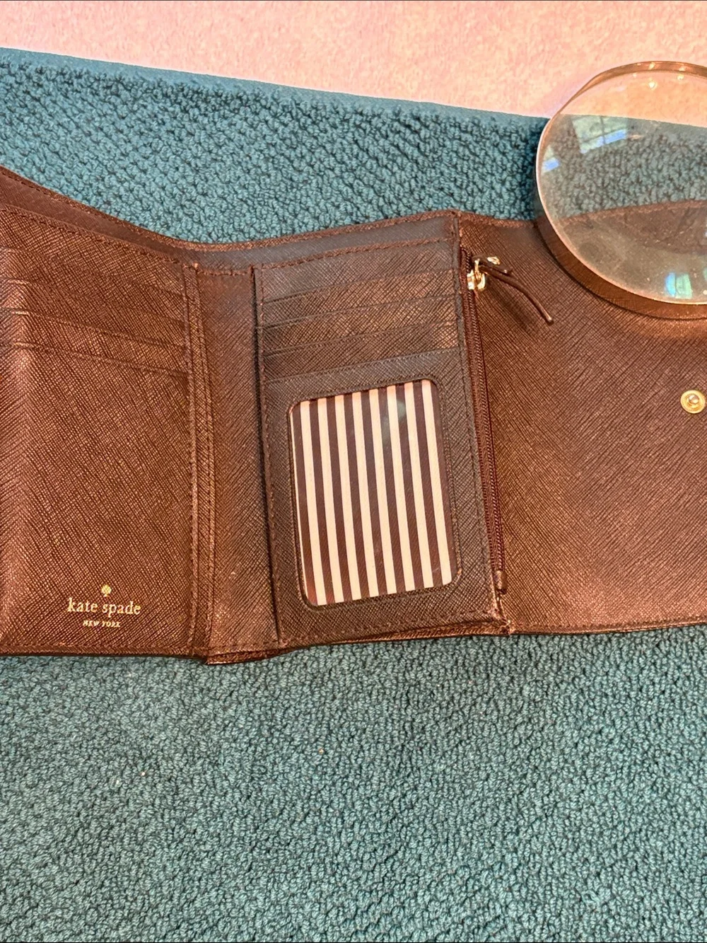 Kate Spade black saffiano tri-fold hand wallet with gold logo